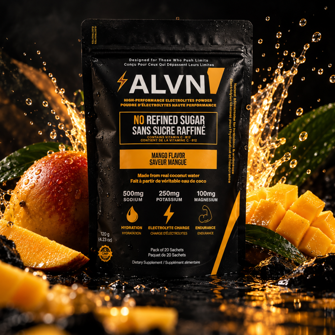 ALVN Mango Flair electrolyte powder in a black stand-up pouch, surrounded by sliced mango, green leaves, and water splashes on a dark background.